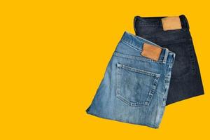 pantaloni in denim piegati, jeans blu e neri isolati su sfondo bianco. foto