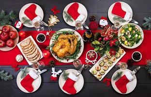 al forno tacchino. Natale cena. il Natale tavolo è servito con un' tacchino, decorato con luminosa orpello e candele. fritte pollo, tavolo. famiglia cena. superiore Visualizza foto