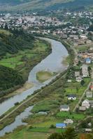 un' bellissimo Visualizza di il villaggio di mezhgorye, carpazi regione. un' lotto di Residenziale edifici circondato di alto foresta montagne e lungo fiume foto