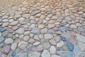 il struttura di il pietra strada, marciapiede, muri di grande grigio vecchio medievale il giro forte pietre, ciottoli. il sfondo foto