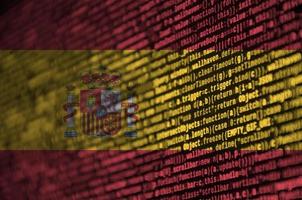 Spagna bandiera è raffigurato su il schermo con il programma codice. il concetto di moderno tecnologia e luogo sviluppo foto