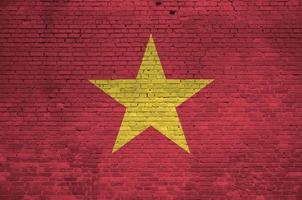 Vietnam bandiera raffigurato nel dipingere colori su vecchio mattone parete. strutturato bandiera su grande mattone parete opere murarie sfondo foto