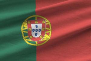 Portogallo bandiera con grande pieghe agitando vicino su sotto il studio leggero al chiuso. il ufficiale simboli e colori nel bandiera foto