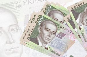 500 ucraino grivna fatture bugie nel pila su sfondo di grande semi trasparente banconota. astratto presentazione di nazionale moneta foto