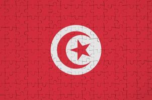 tunisia bandiera è raffigurato su un' piegato puzzle foto