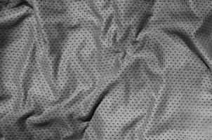 vicino su di grigio poliestere nylon abbigliamento sportivo pantaloncini per creato un' strutturato sfondo foto