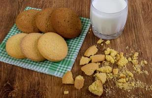 cibo, cibo spazzatura, culinario, cottura al forno e mangiare concetto - vicino su fiocchi d'avena biscotti e latte bicchiere foto