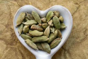 verde cardamomo baccelli nel un' cuore forma foto