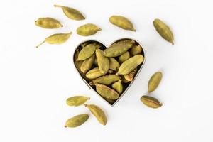 verde cardamomo baccelli nel un' cuore forma foto