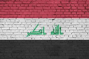 Iraq bandiera è dipinto su un vecchio mattone parete foto