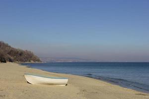 giorno paesaggio di solitario barca su il spiaggia foto