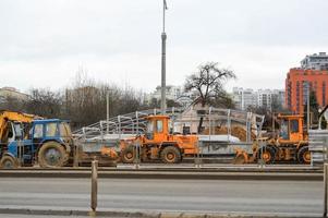 molti potente industriale pesante specializzato costruzione attrezzatura di trattore escavatori e bulldozer rendere strada riparazione durante il costruzione di un' nuovo micro-distretto nel un' grande città foto