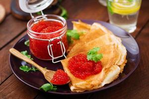 Pancakes con rosso caviale su piatto. russo cucina. maslenitsa foto