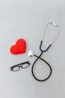 medicina attrezzatura stetoscopio o fonendoscopio bicchieri e rosso cuore isolato su bianca sfondo. strumento dispositivo per medico. Salute cura vita assicurazione concetto foto