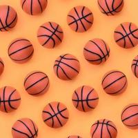 molti piccolo arancia palle per pallacanestro sport gioco bugie su struttura sfondo di moda pastello arancia colore carta nel minimo concetto foto