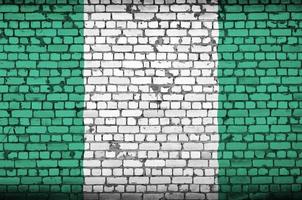 Nigeria bandiera è dipinto su un vecchio mattone parete foto