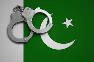 Pakistan bandiera e polizia manette. il concetto di crimine e reati nel il nazione foto