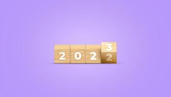 capovolgimento di 2022 per 2023 su di legno bloccare cubo per preparazione nuovo anno modificare e inizio nuovo attività commerciale bersaglio strategia bandiera concetto. 3d illustrazione. foto