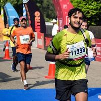 nuovo delhi, India - ottobre 16 2022 - vedanta delhi metà maratona gara dopo covid nel quale maratona partecipanti di per attraversare il finire linea, delhi metà maratona 2022 foto