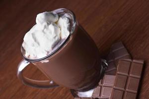 caldo cacao nel un' bicchiere boccale con spazzato crema foto