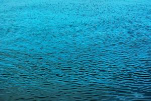 astratto sfondo di fiume acqua flusso sotto il influenza di luce. il struttura di il acqua foto