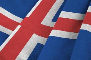 Islanda bandiera con grande pieghe agitando vicino su sotto il studio leggero al chiuso. il ufficiale simboli e colori nel bandiera foto