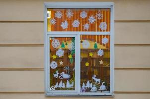 il finestra è decorato con fiocchi di neve, cervo lavorato su di carta. Natale decorazione foto