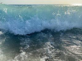 onde, spruzzi di acqua su il spiaggia a il mare su vacanza nel un' turista caldo orientale tropicale nazione meridionale Paradiso ricorrere su vacanza. il sfondo foto