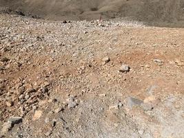 colorato roccioso sporco sabbia terra o ciottolo deserto struttura. senza soluzione di continuità struttura su terra struttura foto