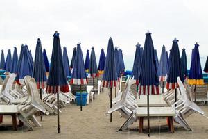 il vuoto spiaggia con un' lotto di lettini e ombrelli nel un' piovoso tempo atmosferico. pattaya, Tailandia. foto