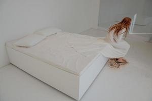 depresso donna seduta su il letto foto