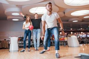 deve essere sciopero. i giovani amici allegri si divertono al bowling club durante i fine settimana foto