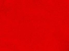 rosso pulito lana struttura sfondo. leggero naturale pecora lana vergine. rosso senza soluzione di continuità cotone. struttura di soffice pelliccia per progettisti Natale giorno. avvicinamento frammento rosso lana tappeto.. foto