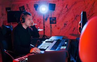 giovane cantato ingegnere Lavorando e miscelazione musica in casa nel il studio foto