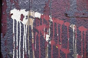 dettagliato e colorato vicino su a Cracked e peeling dipingere su calcestruzzo parete textures nel alto risoluzione foto
