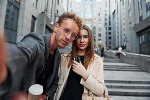 fa autoscatto. donna e uomo nel il cittadina a giorno. bene vestito persone foto