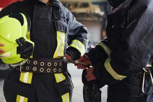 maschio e femmina i vigili del fuoco nel protettivo uniforme in piedi insieme foto