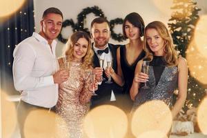 x-mas vacanze. gruppo di persone avere un' nuovo anno festa in casa insieme foto