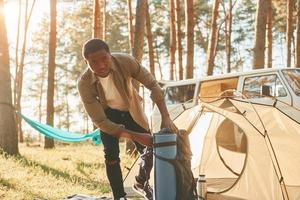 africano americano uomo è in viaggio solo nel il foresta a giorno a estate foto