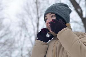 inverno ritratto di giovane ragazza con smartphone foto