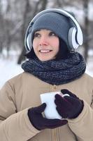 giovane ragazza con cuffie e caffè tazza foto