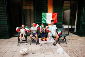 contento quattro bambini con italiano bandiere festeggiare repubblica giorno di Italia. foto