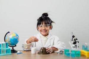 formazione scolastica, scienza, chimica e bambini concetto - bambini o studenti con test tubo fabbricazione sperimentare a scuola laboratorio foto