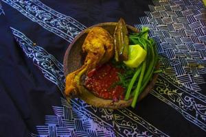 nasi tempo o sego tempo è tradizionale cibo a partire dal banyuwangi, Indonesia fatto a partire dal Riso, tradizionale fritte calamaro, fritte melanzana, cetriolo fette, la verdura, spinaci e speziato Sambal chili foto