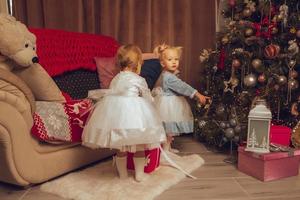 Due poco bambini nel vestiti con un' Natale albero foto