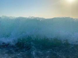 onde, spruzzi di acqua su il spiaggia a il mare su vacanza nel un' turista caldo orientale tropicale nazione meridionale Paradiso ricorrere su vacanza. il sfondo foto