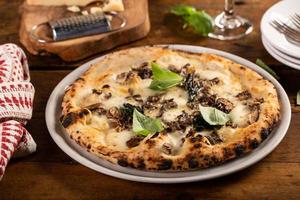 Pizza napoletano o Napoli stile con formaggio, funghi e basilico foto