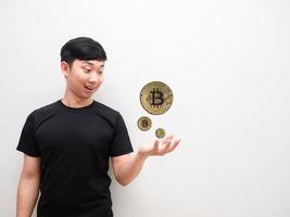 asiatico uomo guardare a bitcoin su mano contento viso e Sorridi il digitale i soldi concetto su bianca isolato sfondo foto
