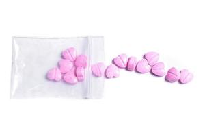 chiusura lampo Borsa e rosa cuore sagomato pillole. foto