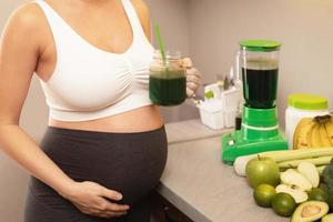contento incinta donna potabile salutare verde frullato foto